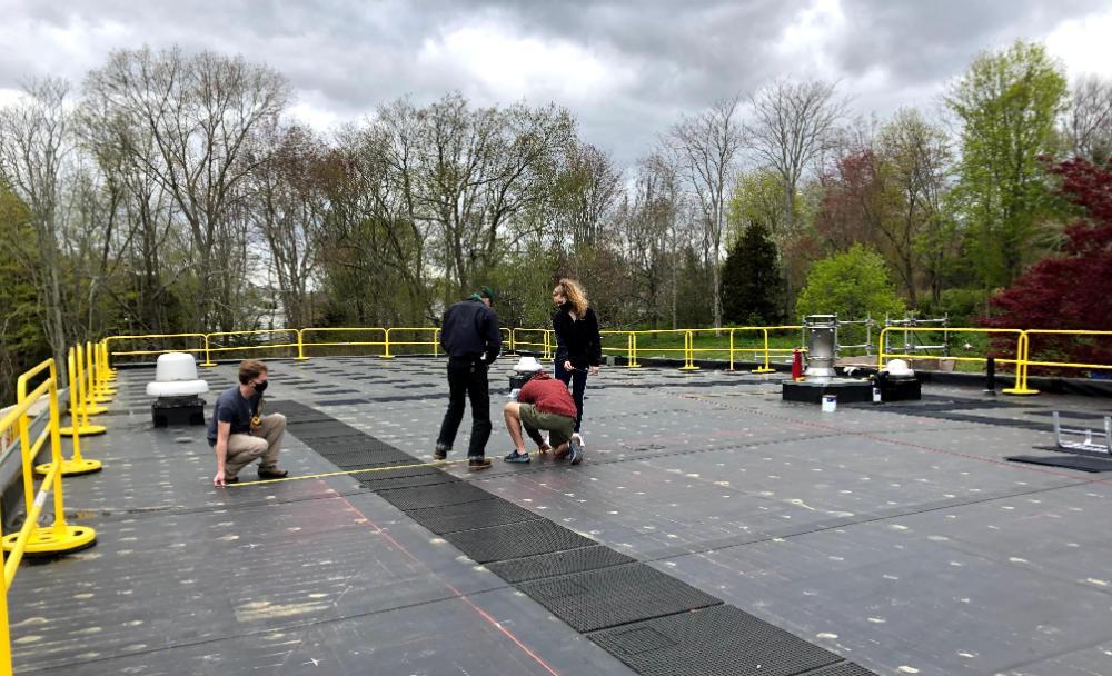 Students measuring for solar array