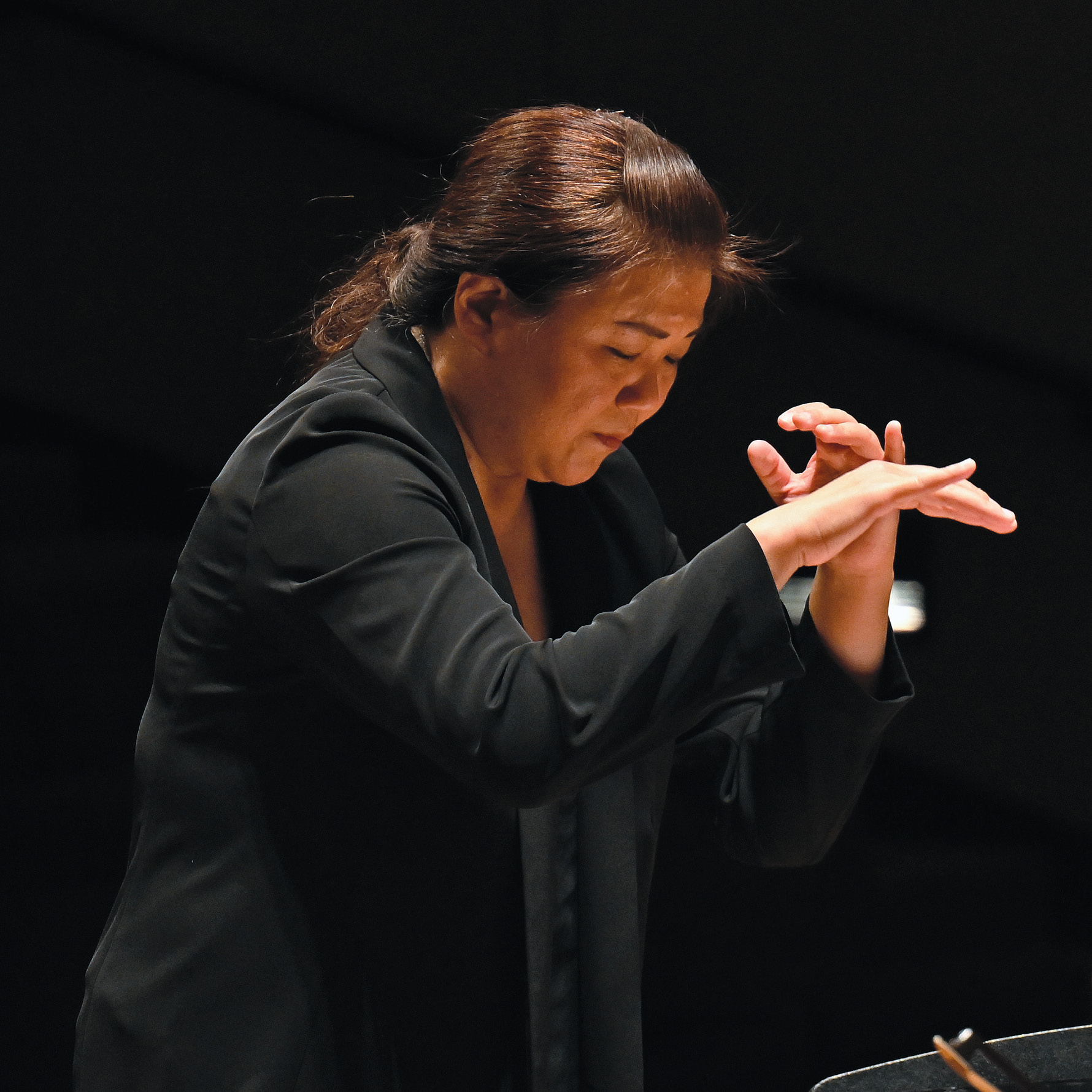 Assistant Professor of Music Shou Ping Liu conducts the New England Chamber Orchestra at Evans Hall in September.