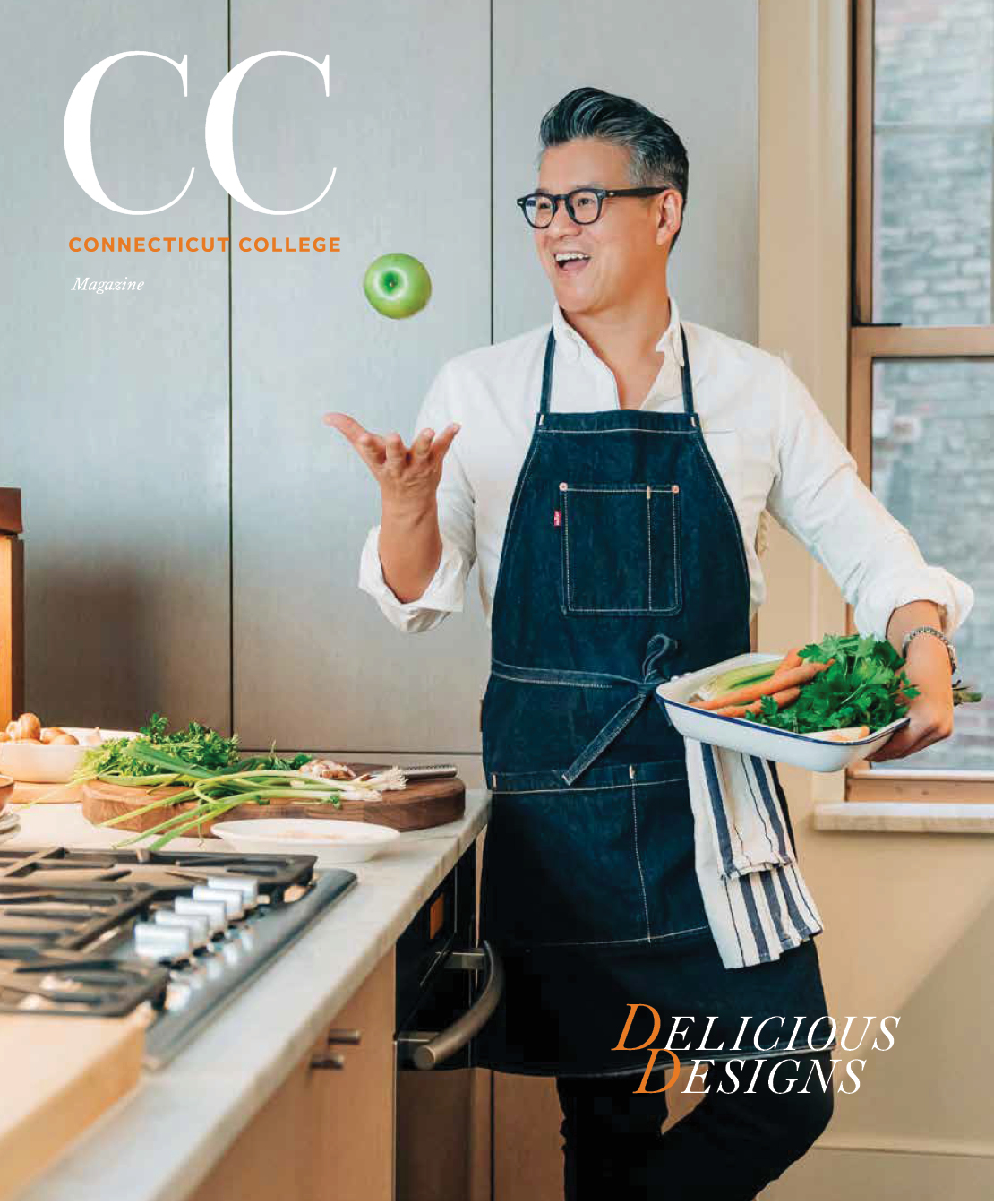 Image of Peter Som in a blue apron tossing an apple