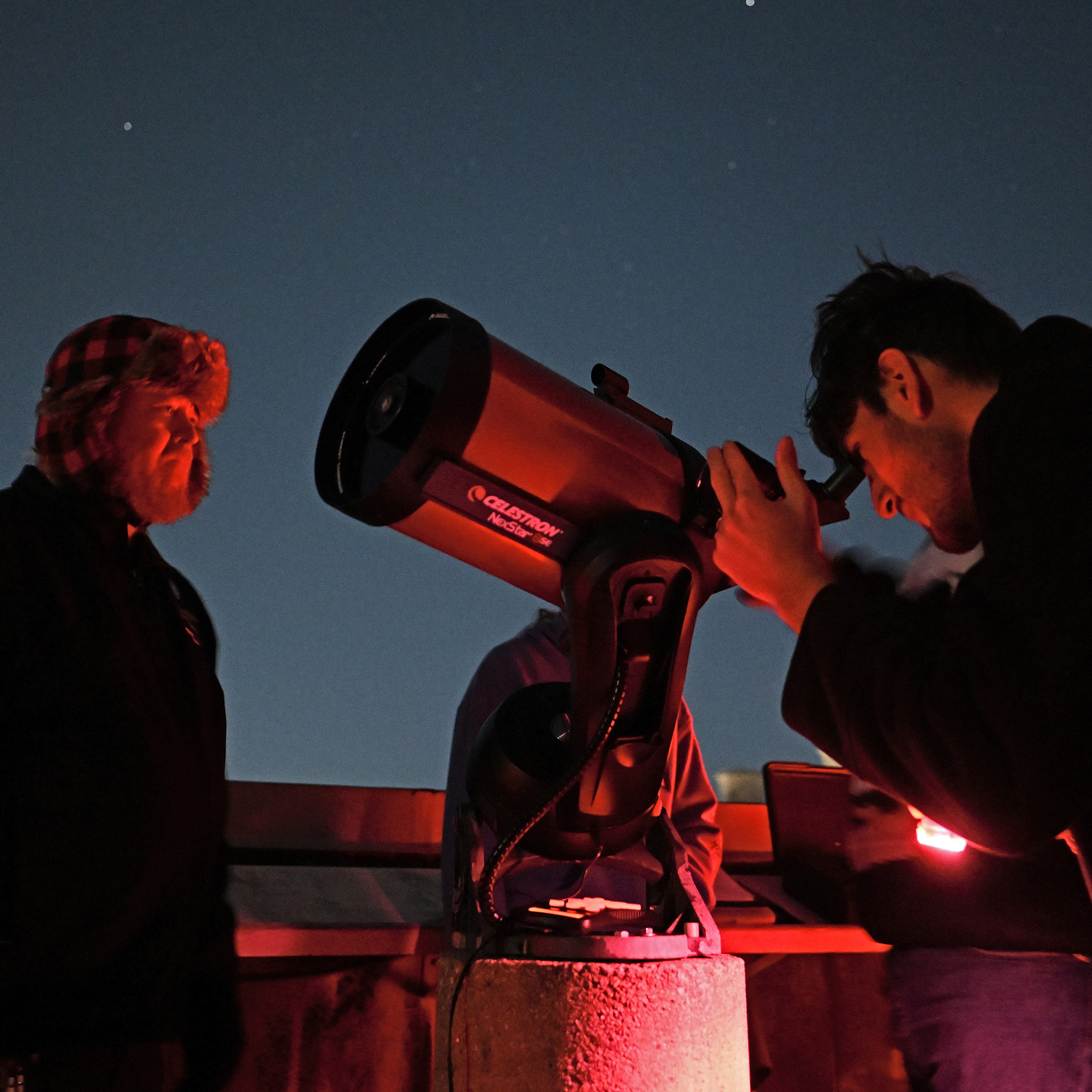 Students look through a telescope at Olin