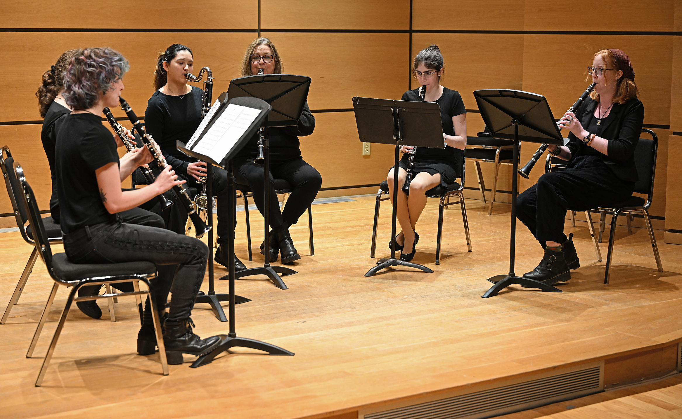 Musicians play clarinets during a recital.