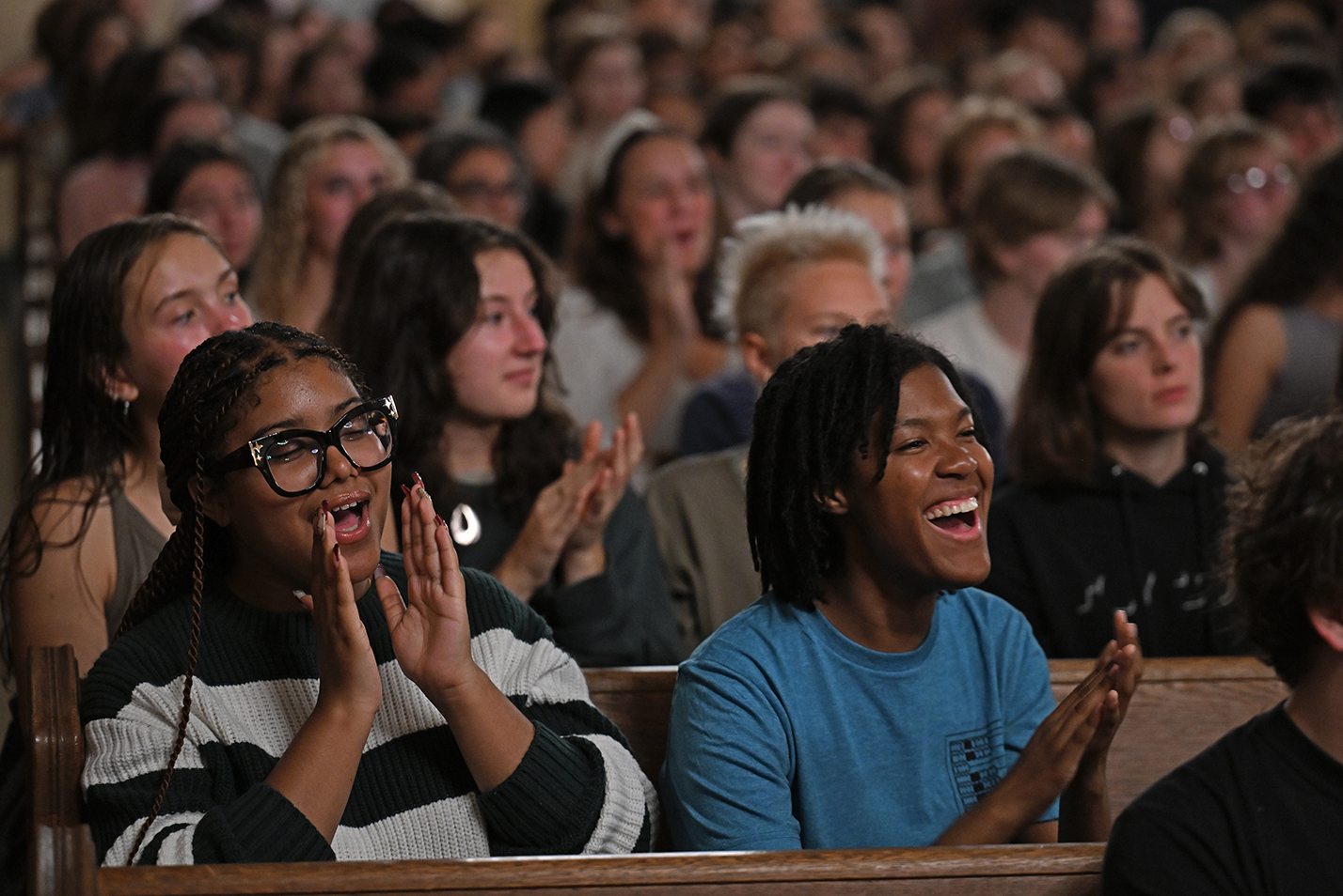 Students clap and cheer during an a cappella performance.