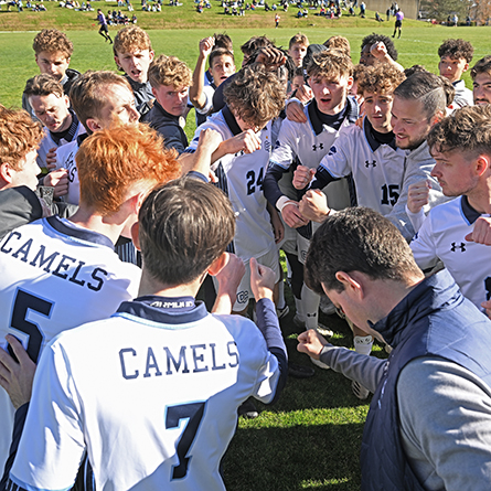 Members of the men's soccer team in a pregame huddle.