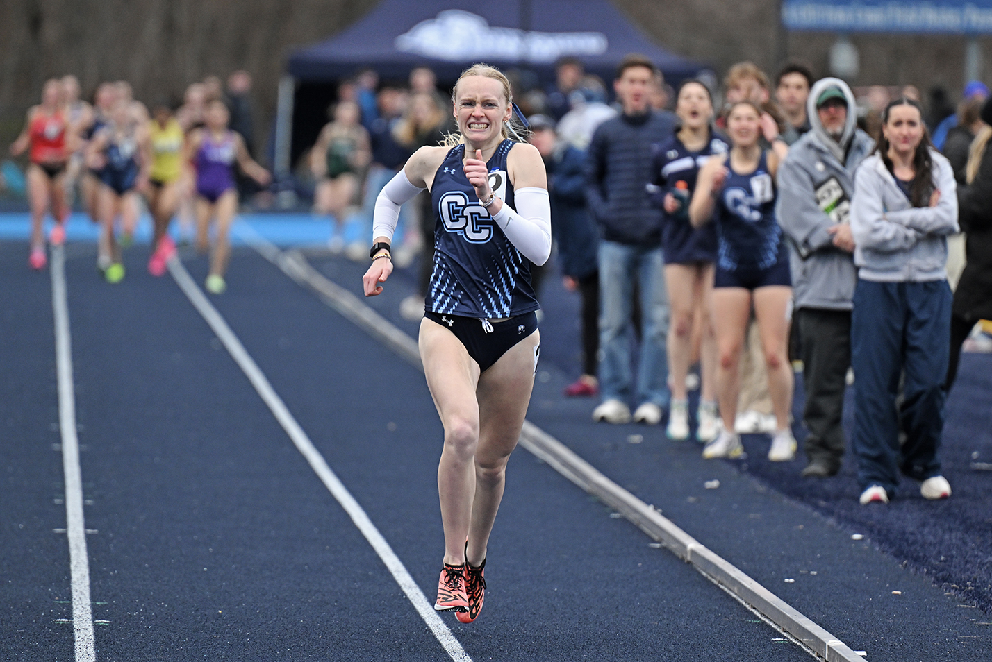 A track runner races to the finish well ahead of the competition.
