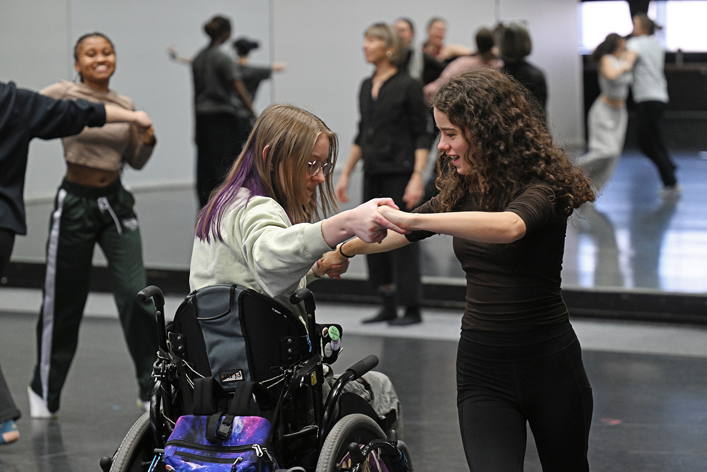 Student actors work on dance choreography for a musical theater production.